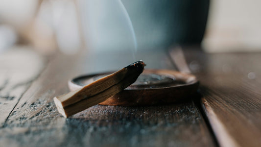 smoking palo santo resting on a tray